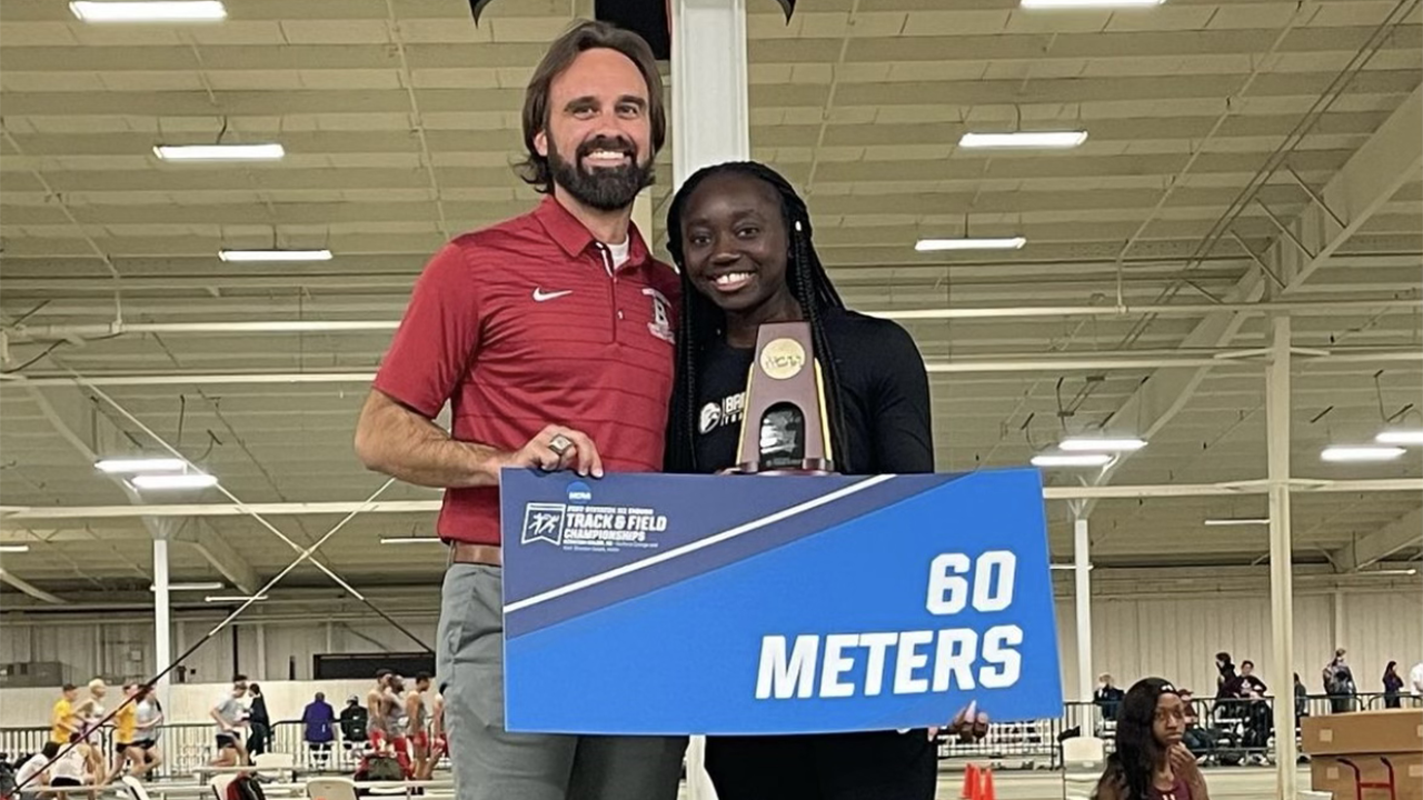 Division III women's 60-meter dash champion Adalia Coleman poses with Bridgewater Director of Cross Country and Track & Field, Denver Davis, at the NCAA Division III Indoor Track & Field Championships.